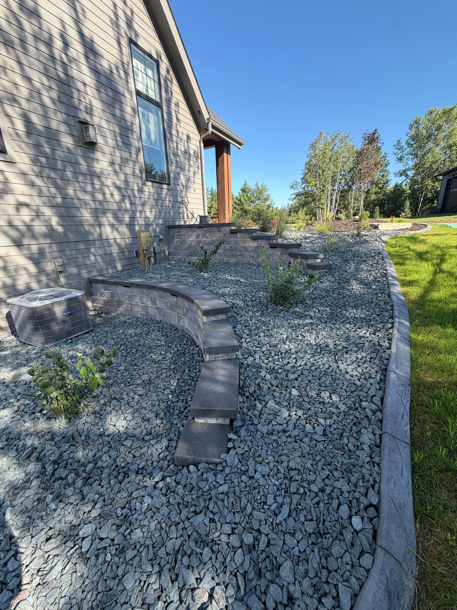 Retaining Walls, Curb Edging and Landscaping Built for a Sloped Property