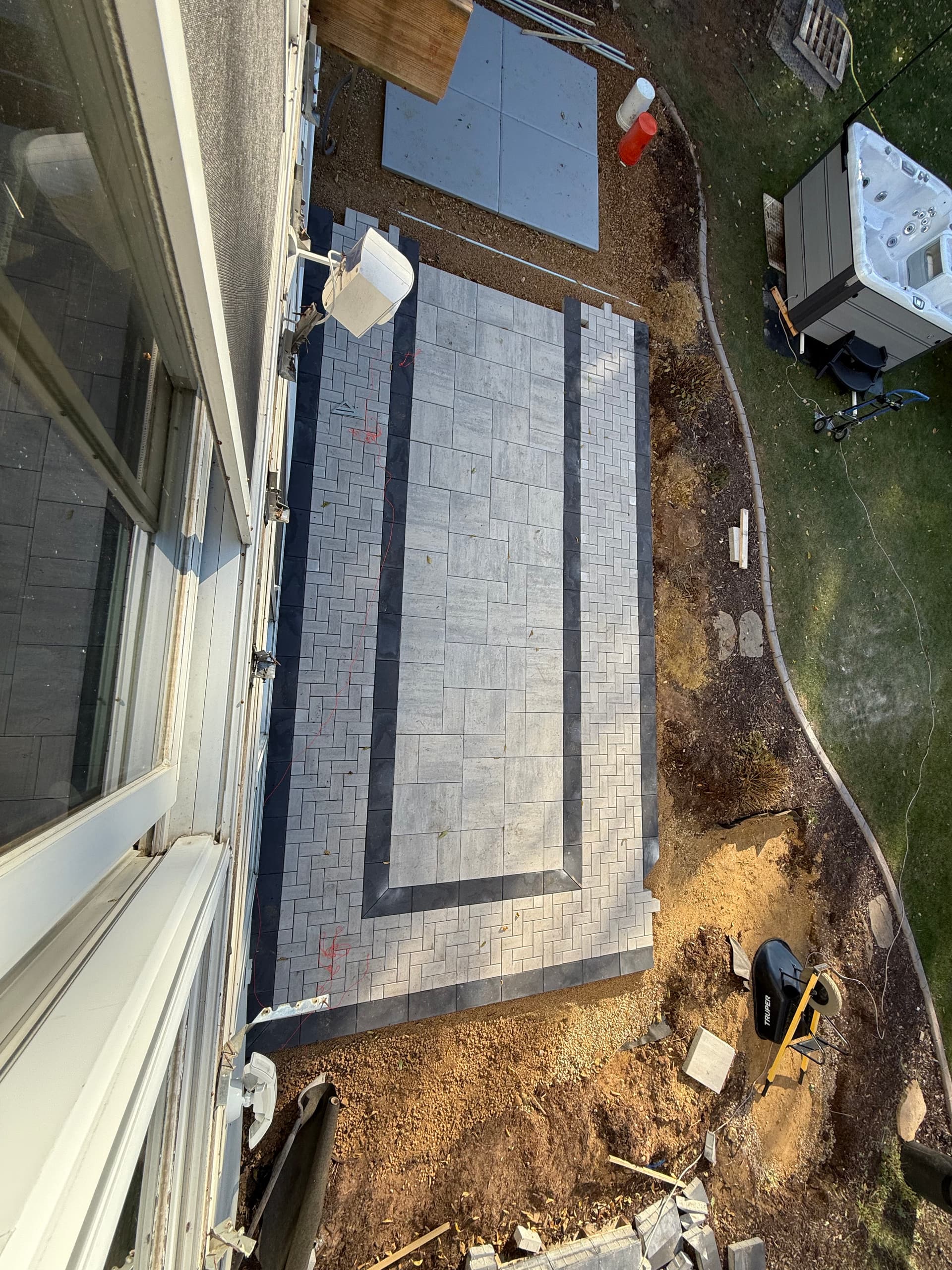 Custom Paver Patio With Hot Tub Pad and Overhead Deck