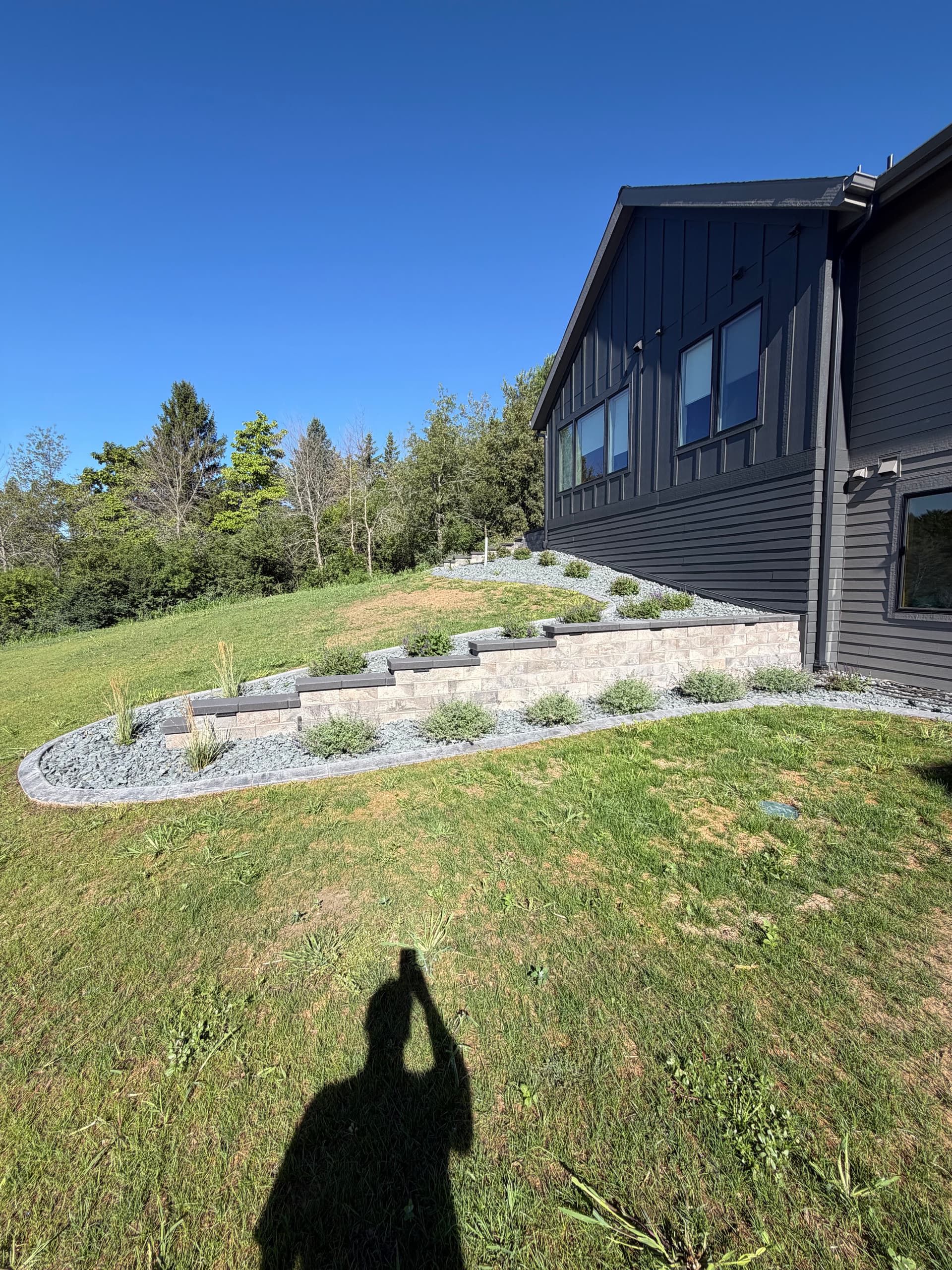 Retaining Walls, Curb Edging and Landscaping Built for a Sloped Property