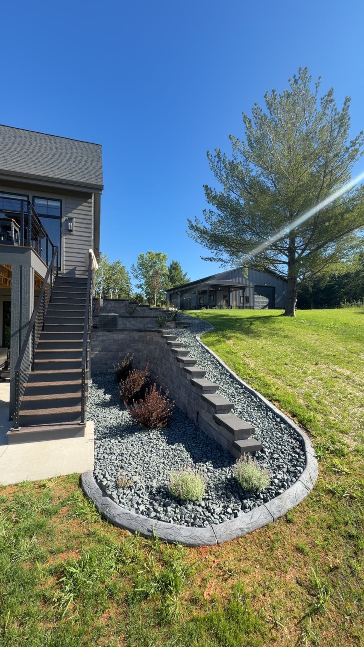 Retaining Walls, Curb Edging and Landscaping Built for a Sloped Property