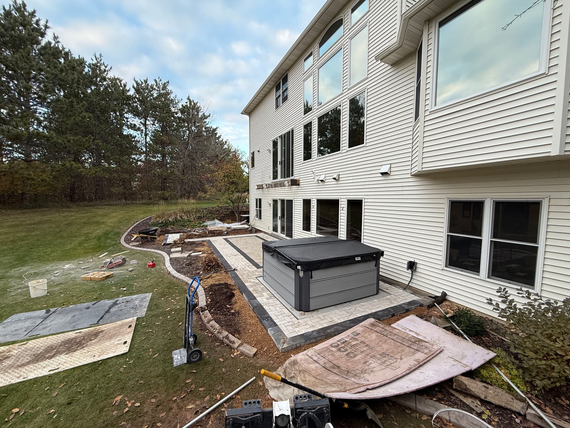 Custom Paver Patio With Hot Tub Pad and Overhead Deck