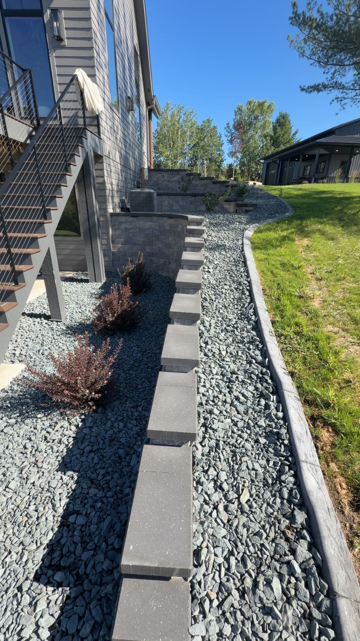 Retaining Walls, Curb Edging and Landscaping Built for a Sloped Property
