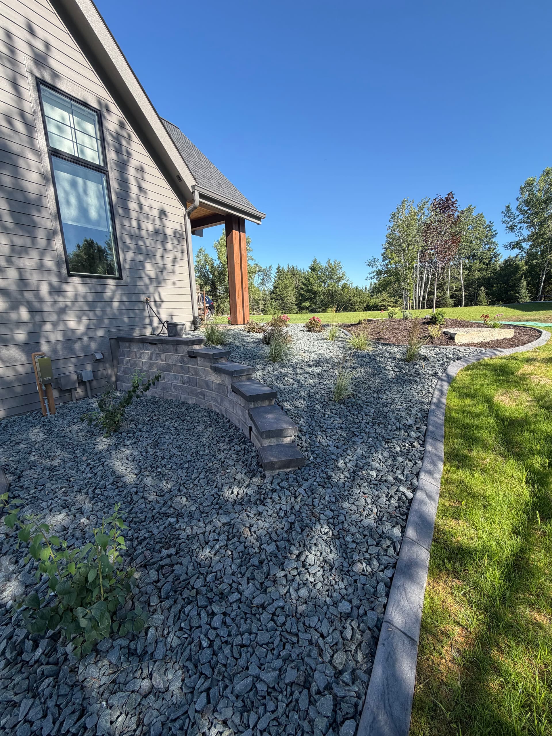 Retaining Walls, Curb Edging and Landscaping Built for a Sloped Property